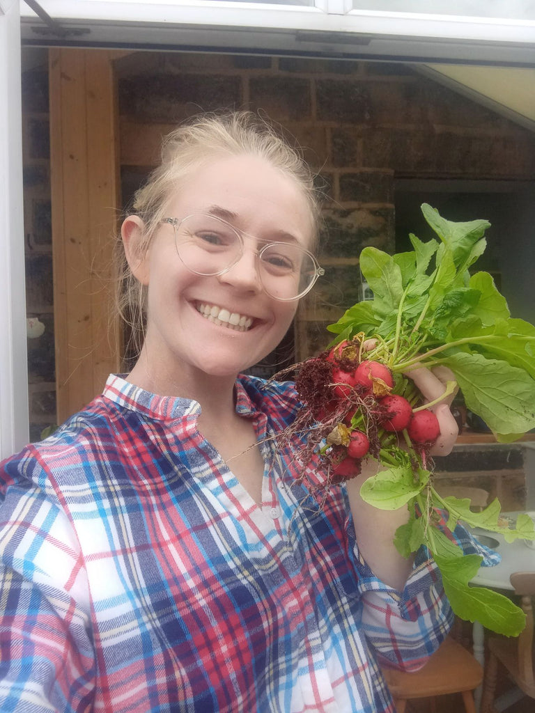 Woman holding home grown vegetables 